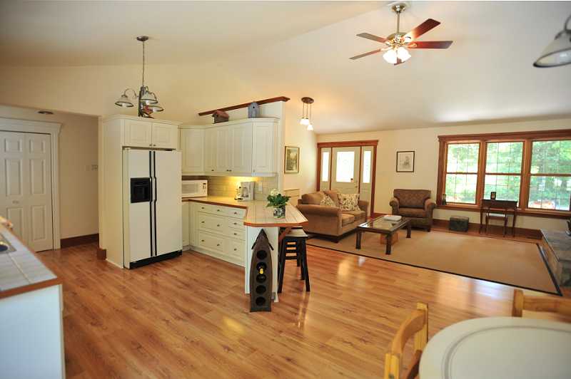 woodburning fireplace, vaulted ceilings, great room, laminate
