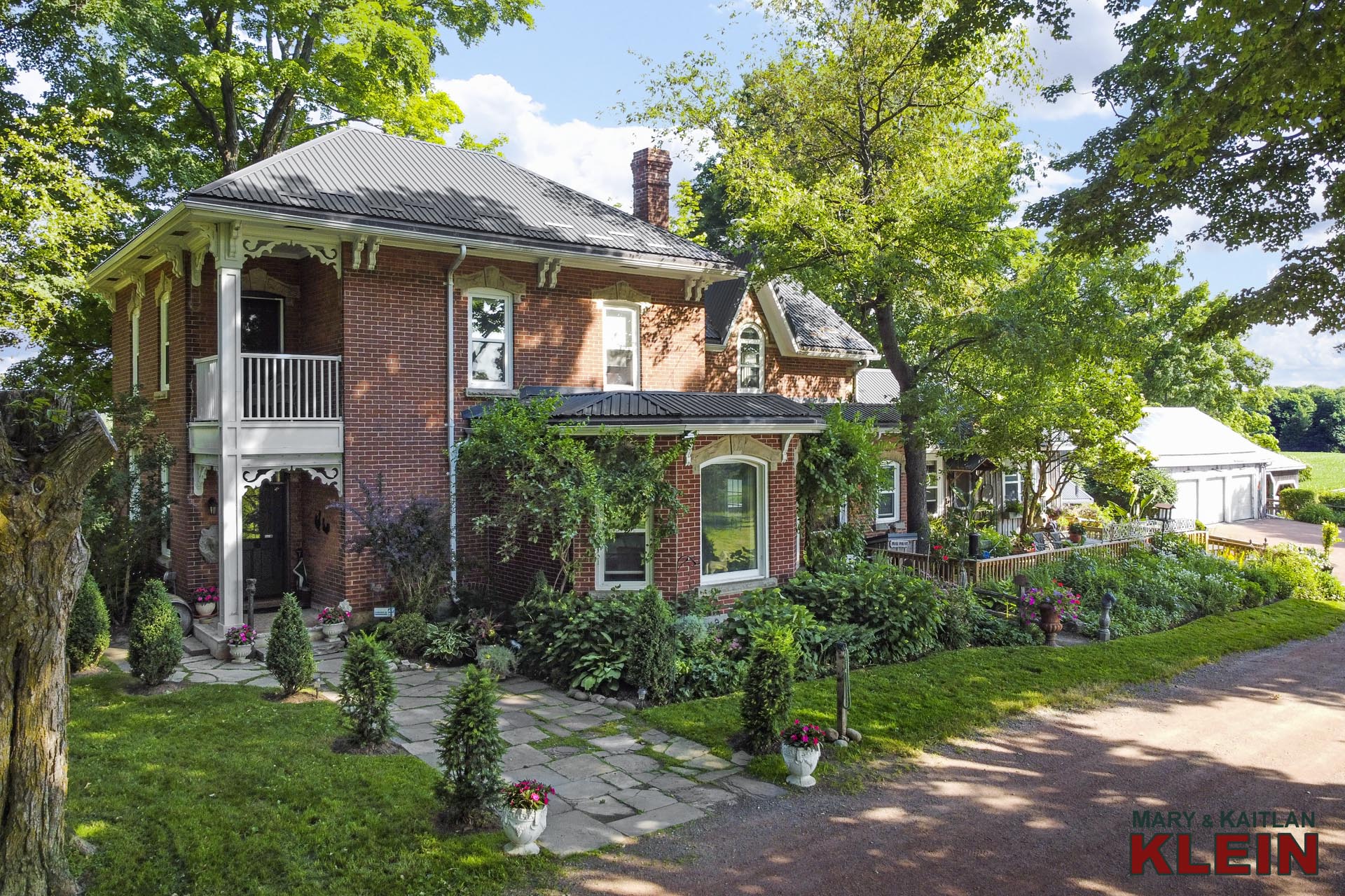 Italiante brick homestead with hip roof and 2-storey inset corner balcony